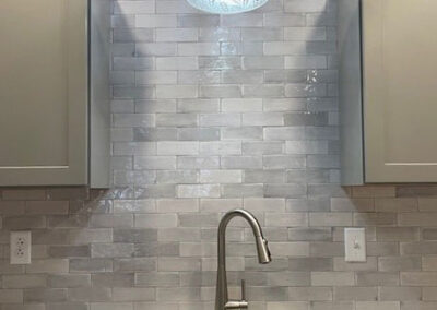 kitchen sink with tile backsplash